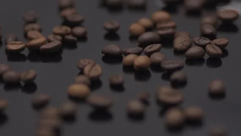 Coffee grains close-up on a dark table. Macro Stock Footage 145792955
