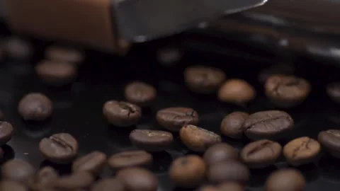 Coffee grains close-up on a dark table. Macro Stock Footage 145792956