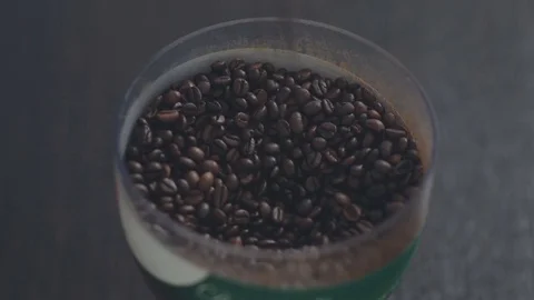 Coffee grains fall into a bowl Stock Footage 76960445
