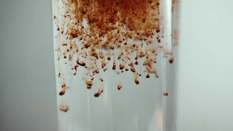 Coffee in granules dissolves in water, subject shooting of a glass of water and Stock-Footage 137855431