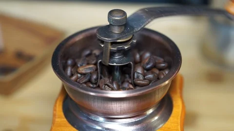 Coffee grinder coffee beans grinding process, macro Stock Footage 104719172