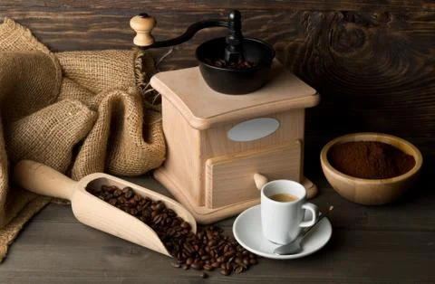 Coffee grinder with coffee beans, ground coffee powder and cup of espresso Stock Photos