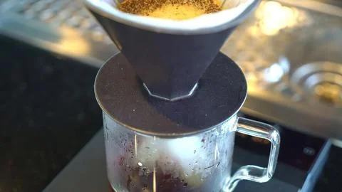 Coffee grinder with coffee beans in a kitchen setting Stock Photos