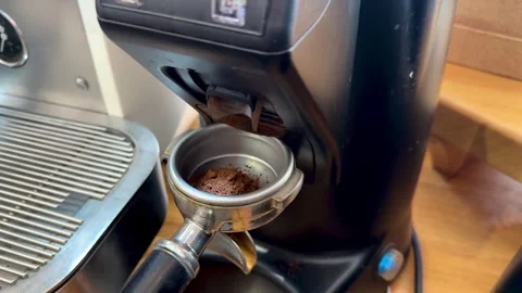 Coffee grinder grinding freshly roasted make beans into a powder Stock Footage 277135708