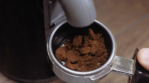 Coffee grinder grinding roasted beans in filter holder. Stock Footage 112681603