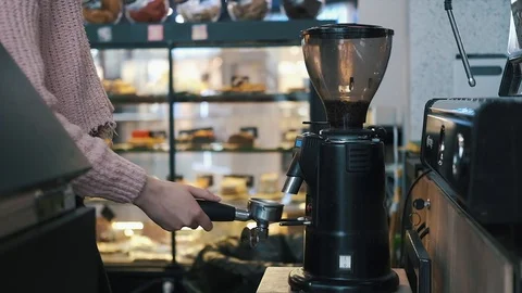 Coffee grinder grinds coffee beans into a filter holder Stock Footage 119236129