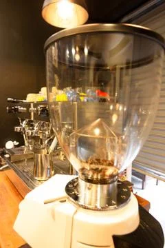 A coffee grinder machine and coffee machine making a cup of coffee in cafe . 스톡 사진