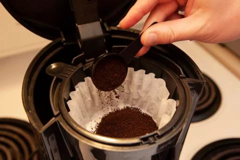 Coffee grinds into the filter Stock Photos