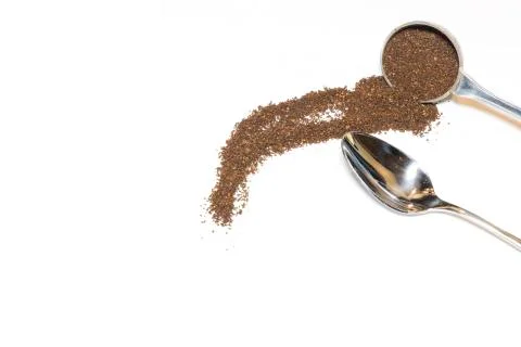 Coffee Grounds and Silver Spoon on White Background Stock Photos