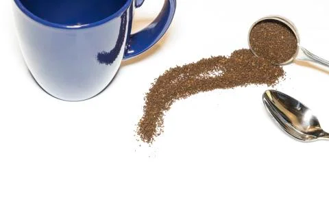Coffee Grounds and Silver Spoon with Blue Mug Handle In on White Background Stock Photos