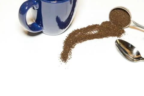 Coffee Grounds and Silver Spoon with Blue Mug Handle Out on White Background Stock Photos