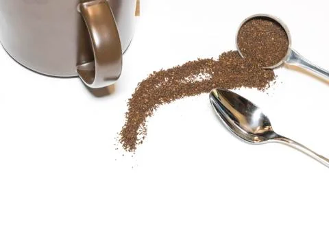 Coffee Grounds and Silver Spoon with Brown Mug Handle In on White Background Stock Photos