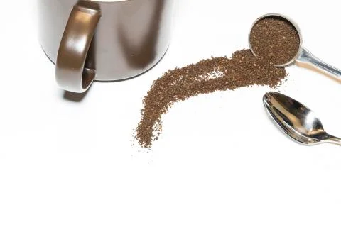 Coffee Grounds and Silver Spoon with Brown Mug Handle Out on White Background Stock Photos
