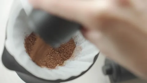 Coffee grounds being added to filter inside coffee dripper Stock Footage 337323968