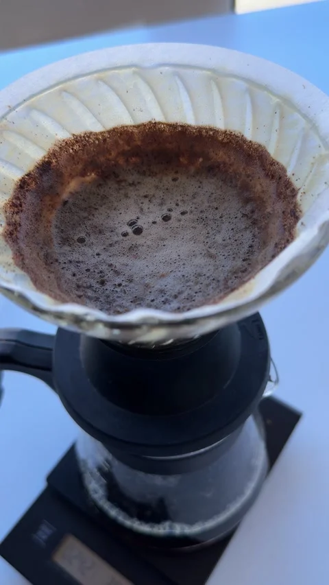 Coffee grounds during the pour-over brewing process, showcasing rich textures Stock Footage 297373627