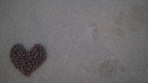 Coffee heart on gray sand Stock Footage 86334075