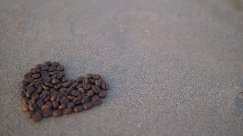 Coffee heart poured on the beach Stock Footage 86334181