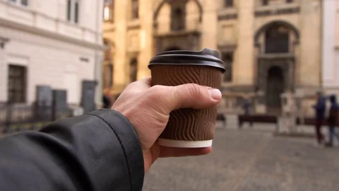 With Coffee In His Hand Is Walking Along The Street, People Are. Coffee On The Stock Footage 103200823