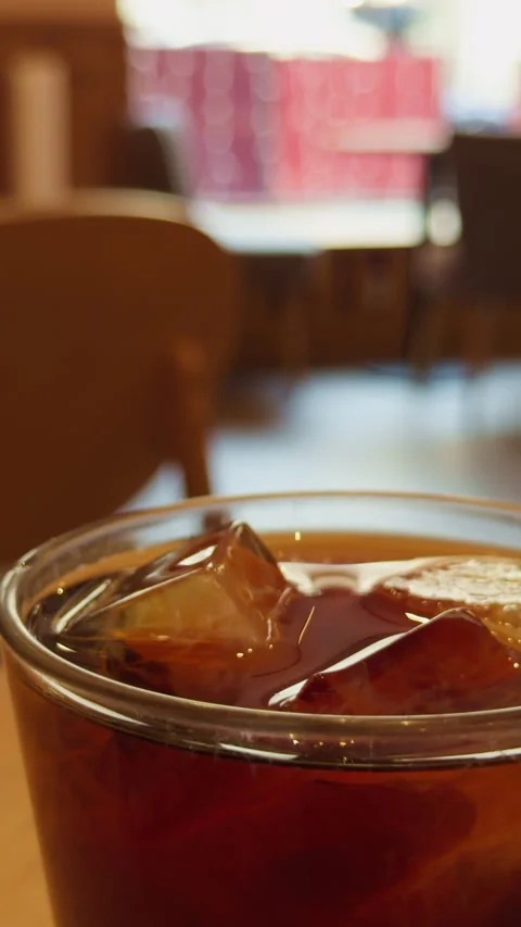 Coffee icy scene. Cold beverage in glass. Close view of chilled coffee drink Stock Footage 332874557