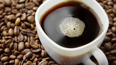 Coffee industry. Cup of coffee with roasted beans. Harvest of tasty coffee Video stock 304314534