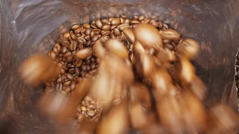 Coffee industry. Process of packing roasted coffee beans. Brown coffee beans. Stock Footage 303698170