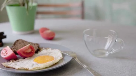 Coffee in jezva and fried egg with tomato. Breakfast on the table. Stock Footage 80177406