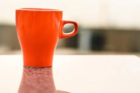Coffee kept on a marble table and sun rising in the background Stock Photos
