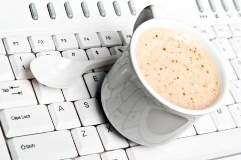 Coffee on keyboard 스톡 사진