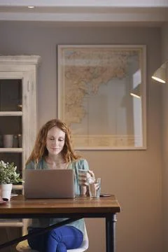Coffee, laptop and remote work with woman in home for planning, research or Stock Photos