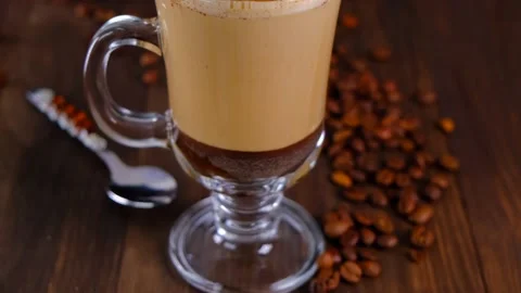 Coffee latte on a brown background with coffee beans. Stock Footage 155681985