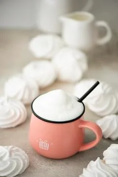 Coffee latte in a large pink mug with white marshmallows Stock Photos