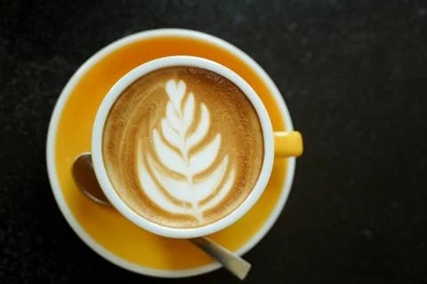 Coffee Latte leaf pattern face on black table Stock Photos