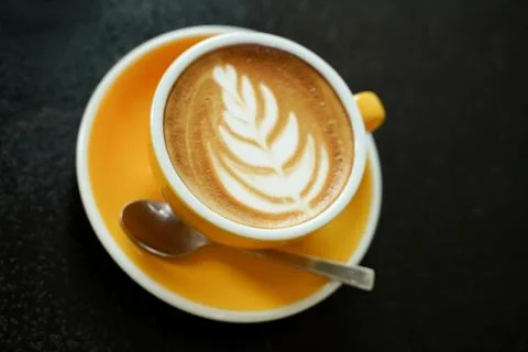 Coffee Latte leaf pattern face on black table Stock Photos
