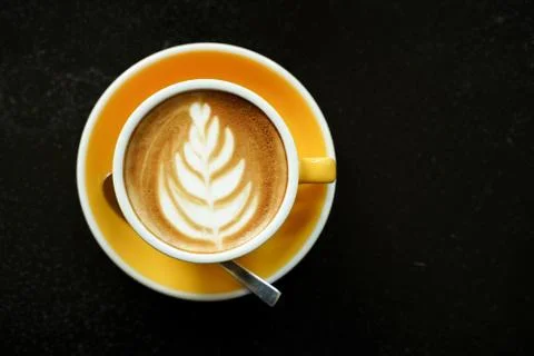 Coffee Latte leaf pattern face on black table Stock Photos