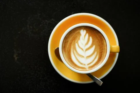 Coffee Latte leaf pattern face on black table Stock Photos