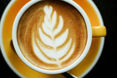 Coffee Latte leaf pattern face on black table Stock Photos