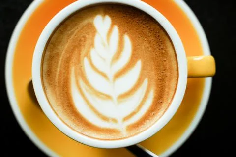 Coffee Latte leaf pattern face on black table Stock Photos