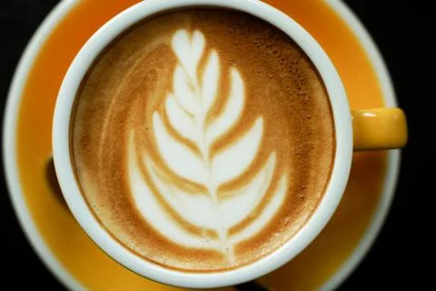 Coffee Latte leaf pattern face on black table Stock Photos