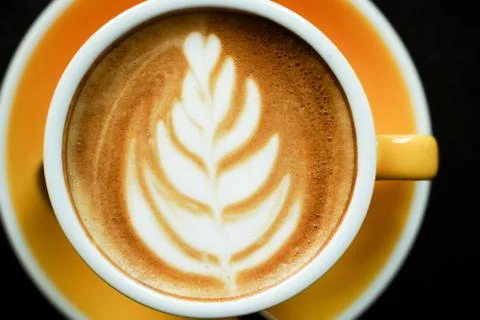 Coffee Latte leaf pattern face on black table Stock Photos