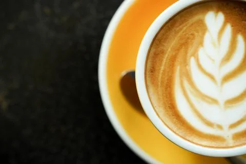 Coffee Latte leaf pattern face on black table Stock Photos