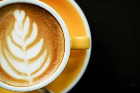 Coffee Latte leaf pattern face on black table Stock Photos