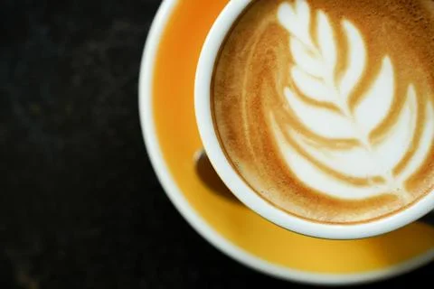 Coffee Latte leaf pattern face on black table Stock Photos