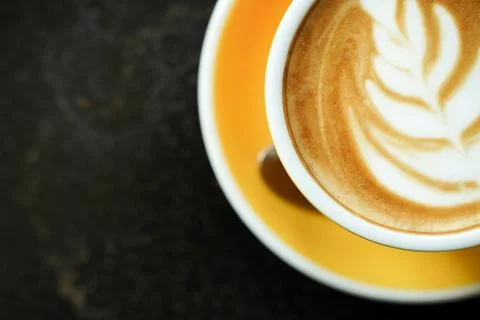 Coffee Latte leaf pattern face on black table Stock Photos