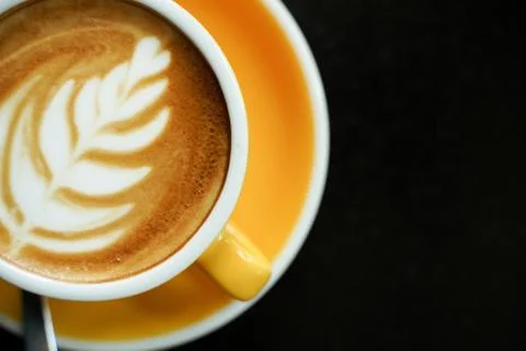 Coffee Latte leaf pattern face on black table Stock Photos