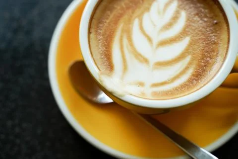 Coffee Latte leaf pattern face on black table Stock Photos