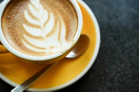 Coffee Latte leaf pattern face on black table Stock Photos