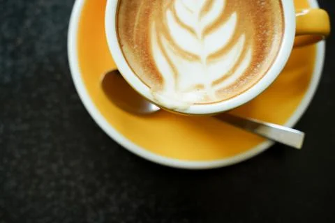 Coffee Latte leaf pattern face on black table Stock Photos