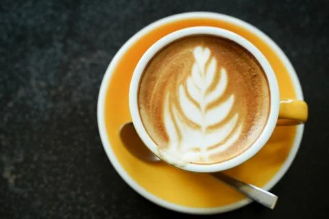 Coffee Latte leaf pattern face on black table Stock Photos