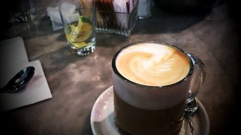 Coffee latte in white cup on the table. Drawing on a latte. Latte art coffee. Mo Stock Footage 85278033