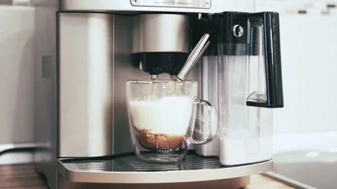 The coffee machine adds coffee to the cream and they mix slowly Stock Footage 144657241